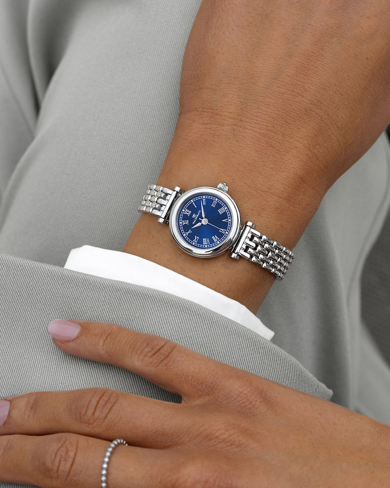 A round womens watch in Rhodium-plated 316L stainless steel from Waldor & Co. with blue Sapphire Crystal glass dial. Seiko movement. The model is Venia 24 Villefranche.