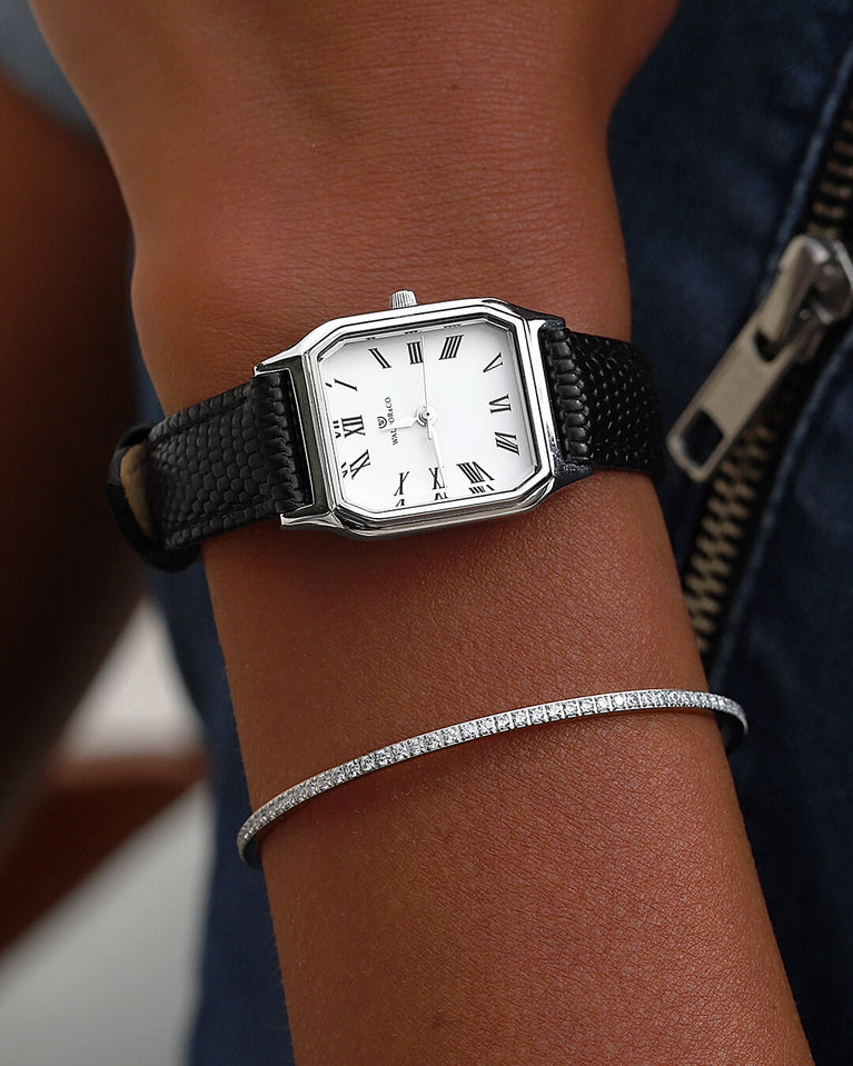 A square womens watch in Rhodium-plated 316L stainless steel from Waldor & Co. with white Diamond Cut Sapphire Crystal glass dial. Strap in black Genuine leather. Seiko movement. The model is Eternal 22 Varenna.