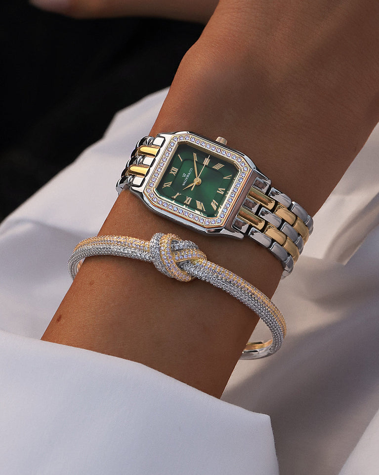 A square womens watch in Rhodium-plated 316L stainless steel from Waldor & Co. with emerald green dial. Bezel with premium crystals. Diamond Cut Sapphire Crystal glass dial. Seiko movement. The model is Eternal 22 Bellagio Pavè.