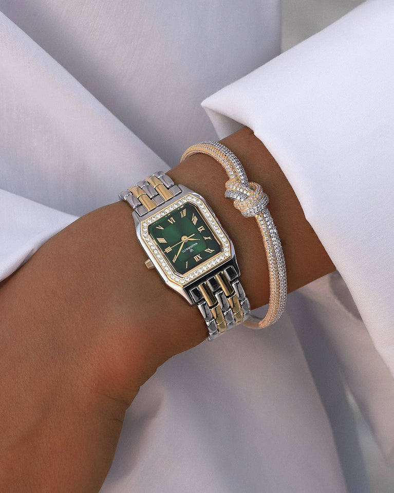 A square womens watch in Rhodium-plated 316L stainless steel from Waldor & Co. with emerald green dial. Bezel with premium crystals. Diamond Cut Sapphire Crystal glass dial. Seiko movement. The model is Eternal 22 Bellagio Pavè.
