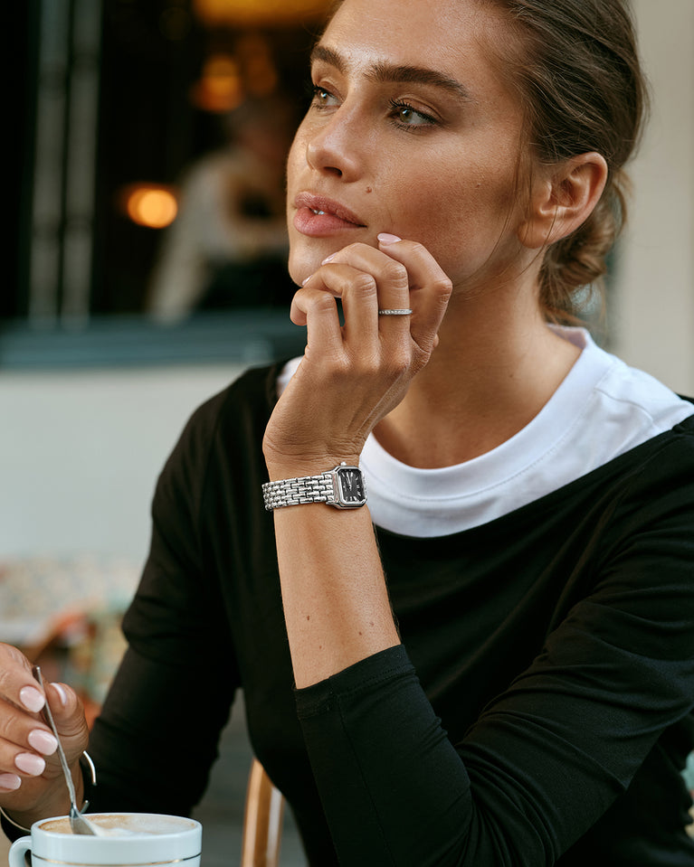 A square womens watch in Rhodium-plated 316L stainless steel from Waldor & Co. with black Diamond Cut Sapphire Crystal glass dial. Seiko movement. The model is Eternal 22 Bellagio.