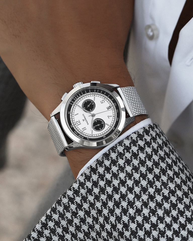 A round mens watch in rhodium-plated silver from Waldor & Co. with panda patterned dial and a second hand. Seiko movement. The model is Chrono 44 Sardinia Panda 44mm.
