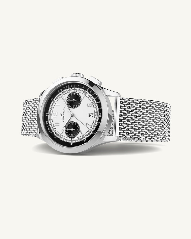 A round mens watch in rhodium-plated silver from Waldor & Co. with panda patterned dial and a second hand. Seiko movement. The model is Chrono 44 Sardinia Panda 44mm.
