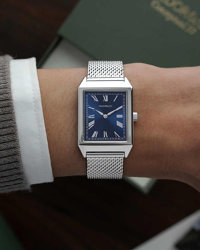A square mens watch in rhodium-plated silver from Waldor & Co. with blue sunray dial. Miyota movement. The model is Conceptual 37 Antibes.