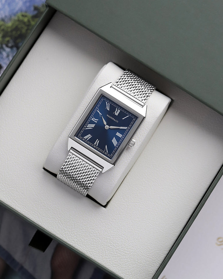 A square mens watch in rhodium-plated silver from Waldor & Co. with blue sunray dial. Miyota movement. The model is Conceptual 37 Antibes.