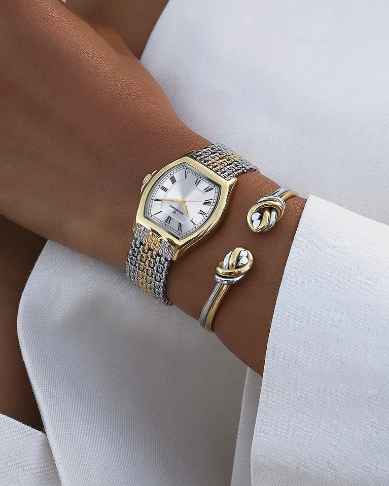 A square womens watch in 22k two-toned silver and gold plated 316L stainless steel from Waldor & Co. with domed mineral glass dial. Seiko movement. The model is Constant 36 Menaggio.