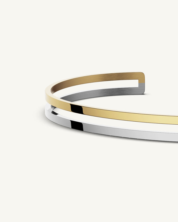 A bangle in 14k gold-plated 316L stainless steel from Waldor & Co. One size. The model is Dual Bangle Polished.