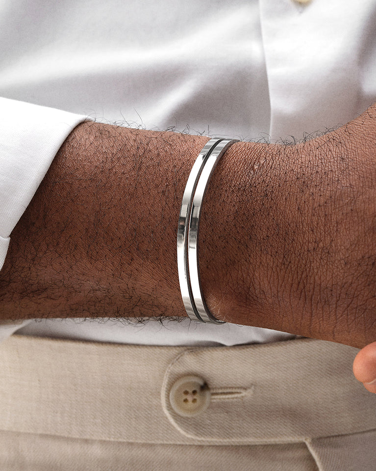 A polished stainless steel bangle in silver from Waldor & Co. One size. The model is Dual Bangle Polished.