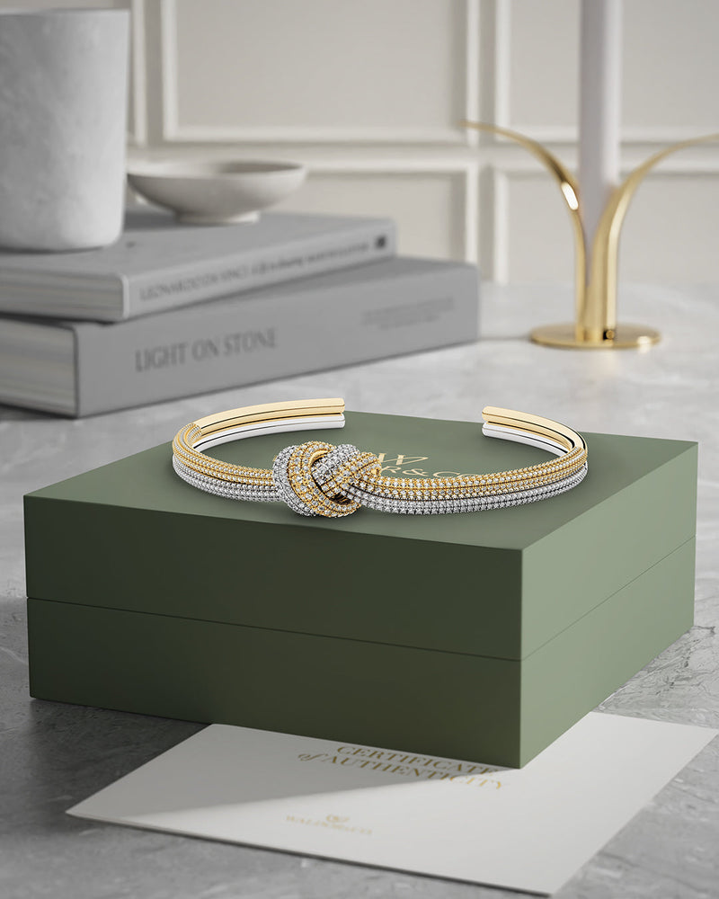 A Bangle in 14k-gold plated and silver polished copper from Waldor & Co. One size. The model is Dual Knot Bangle Pavè.