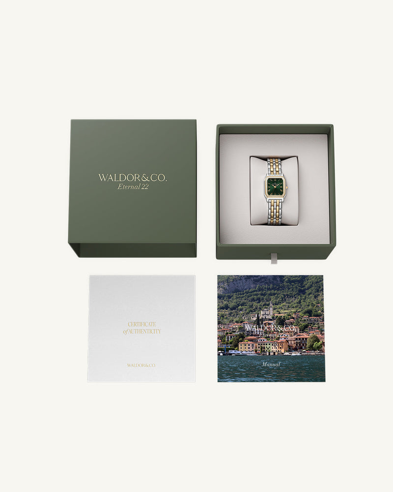 A square womens watch in Rhodium-plated 316L stainless steel from Waldor & Co. with emerald green dial. Bezel with premium crystals. Diamond Cut Sapphire Crystal glass dial. Seiko movement. The model is Eternal 22 Bellagio Pavè.