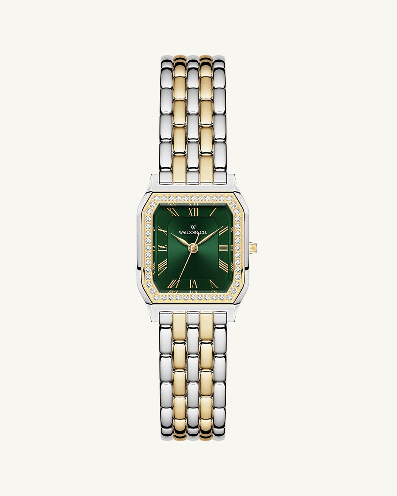 A square womens watch in Rhodium-plated 316L stainless steel from Waldor & Co. with emerald green dial. Bezel with premium crystals. Diamond Cut Sapphire Crystal glass dial. Seiko movement. The model is Eternal 22 Bellagio Pavè.