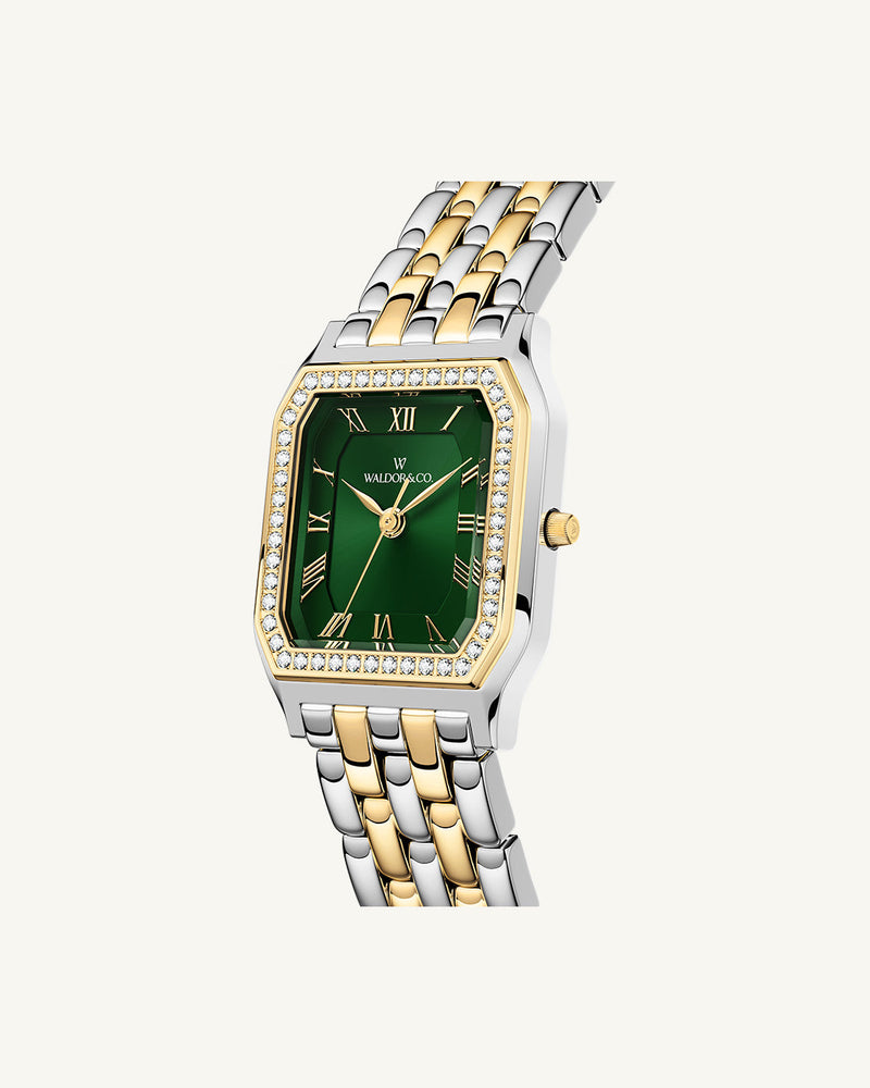 A square womens watch in Rhodium-plated 316L stainless steel from Waldor & Co. with emerald green dial. Bezel with premium crystals. Diamond Cut Sapphire Crystal glass dial. Seiko movement. The model is Eternal 22 Bellagio Pavè.