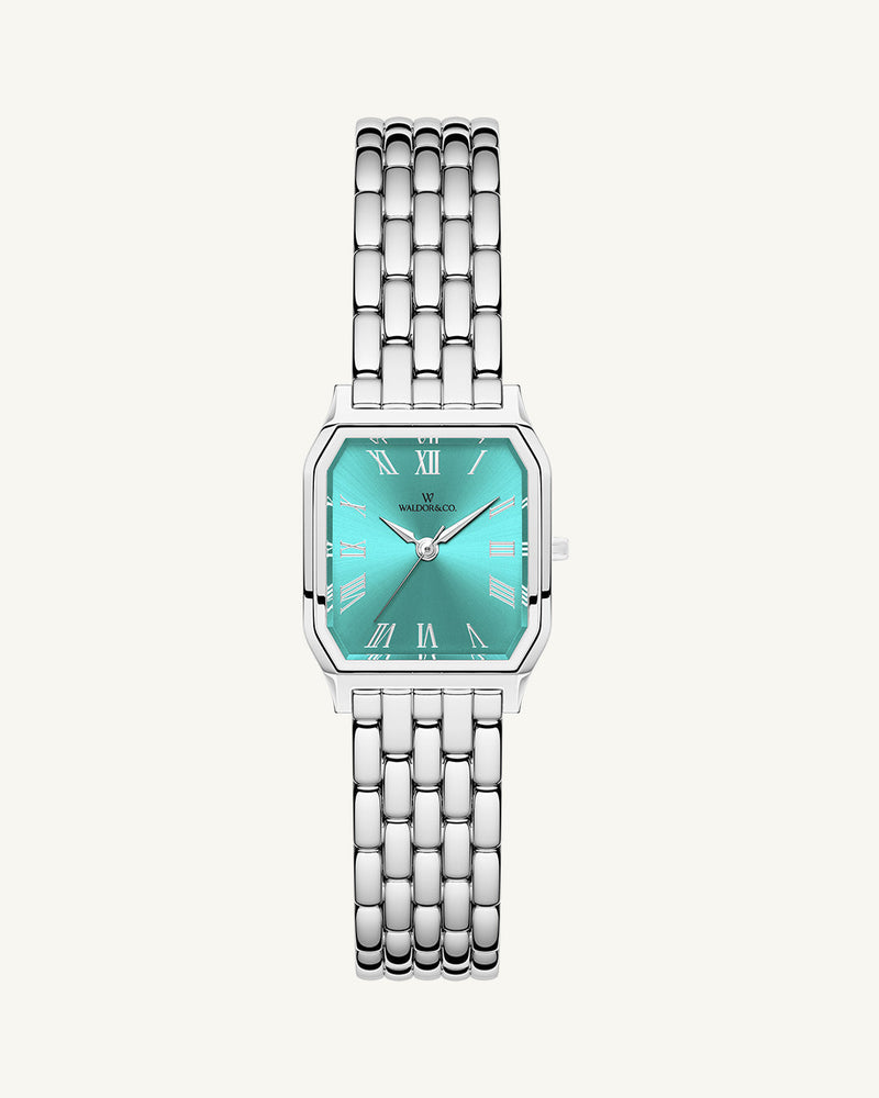 A square womens watch in Rhodium-plated 316L stainless steel from Waldor & Co. with turquoise Diamond Cut Sapphire Crystal glass dial. Seiko movement. The model is Eternal 22 Bellagio.