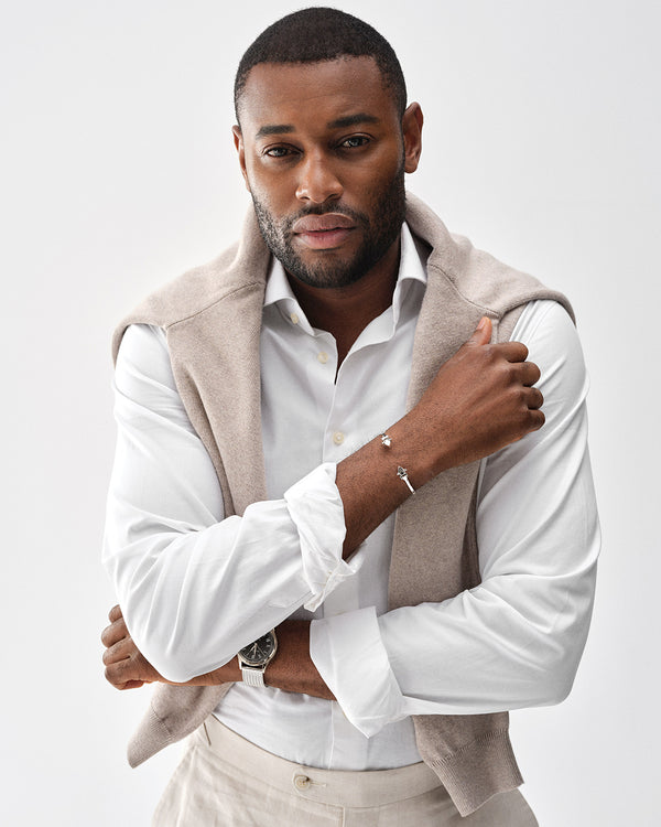 A polished stainless steel bangle in silver from Waldor & Co. One size. The model is Icon Bangle Polished.