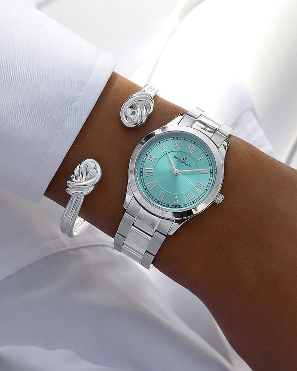 A round womens watch in silver from Waldor & Co. with turquoise sunray dial and a second hand. Seiko movement. The model is Imperial 32 Nocelle 32mm.