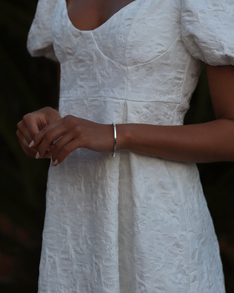 A Square Bangle in 925 Sterling Silver from Waldor & Co. The model is Pure Bangle Sterling Silver