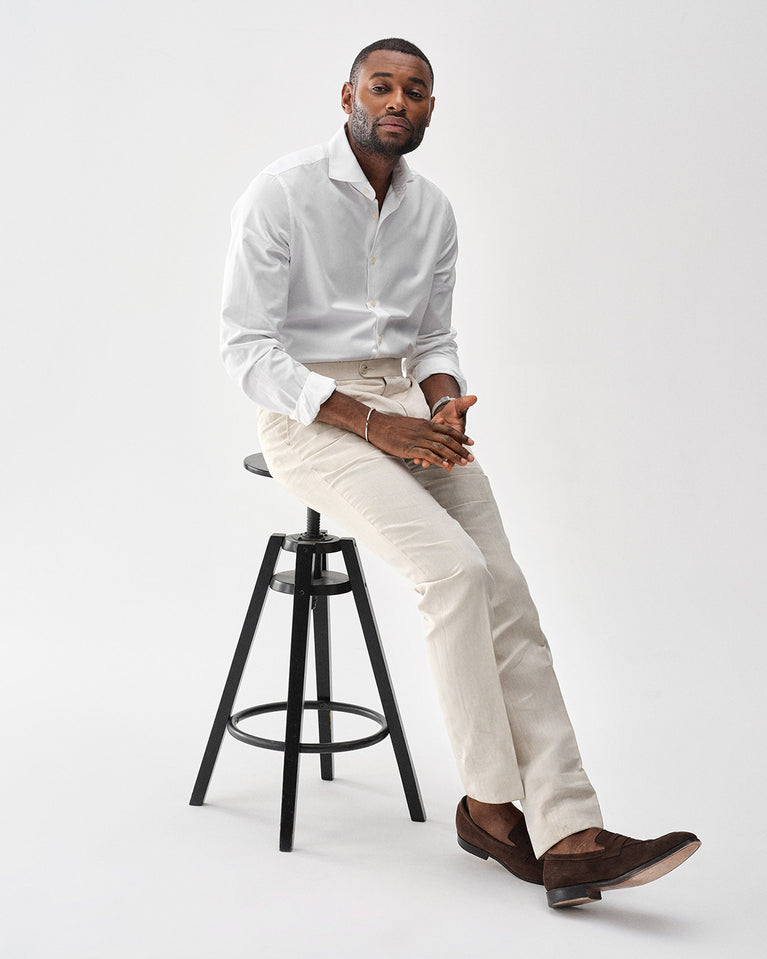 A polished stainless steel bangle in silver from Waldor & Co. One size. The model is Square Bangle Polished