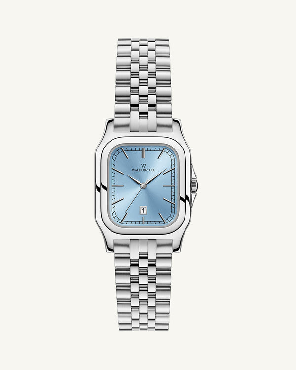 A square womens watch in silver and 14k gold from Waldor & Co. with light blue sunray dial and a second hand. Seiko movement. The model is Delight 32 Chelsea 28x32mm.
