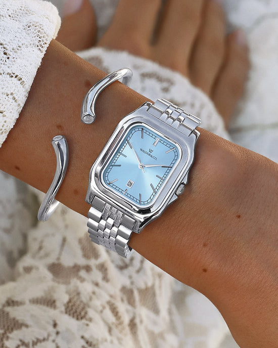 lifestyle_image, A square womens watch in 316L stainless steel from Waldor & Co. with blue Diamond Cut Sapphire Crystal glass dial. Seiko movement. The model is Delight 32 Chelsea