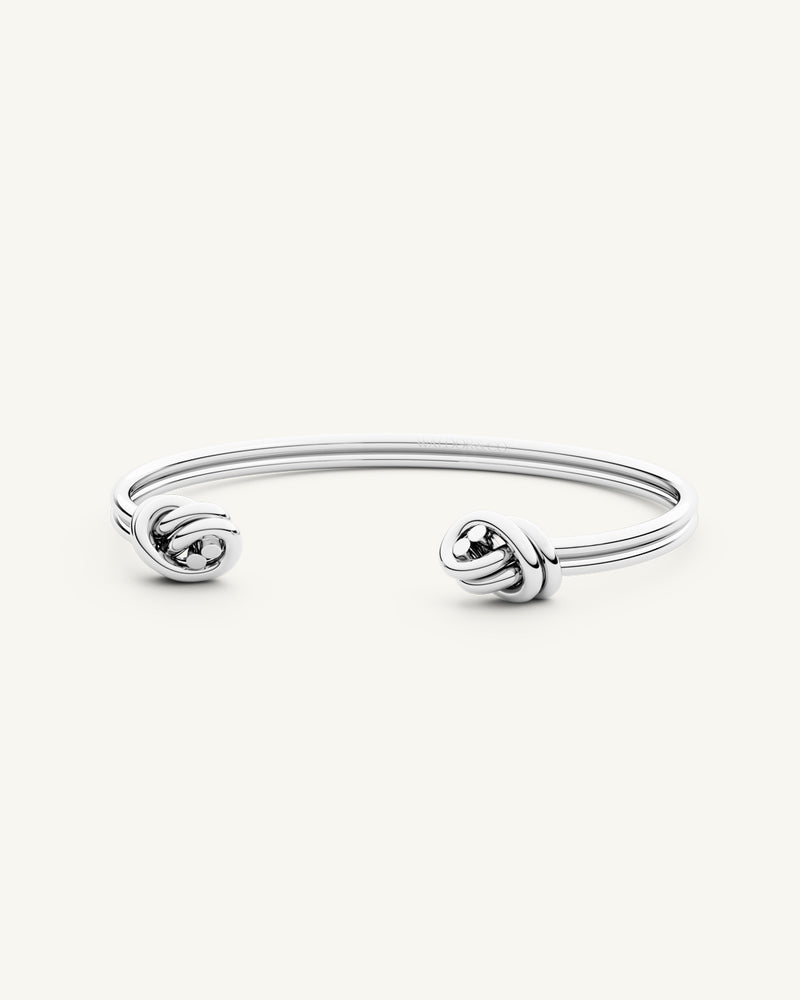 A Bangle Bracelet in polished Silver plated-316L stainless steel from Waldor & Co. The model is Dual Knot Twin Bangle Polished.