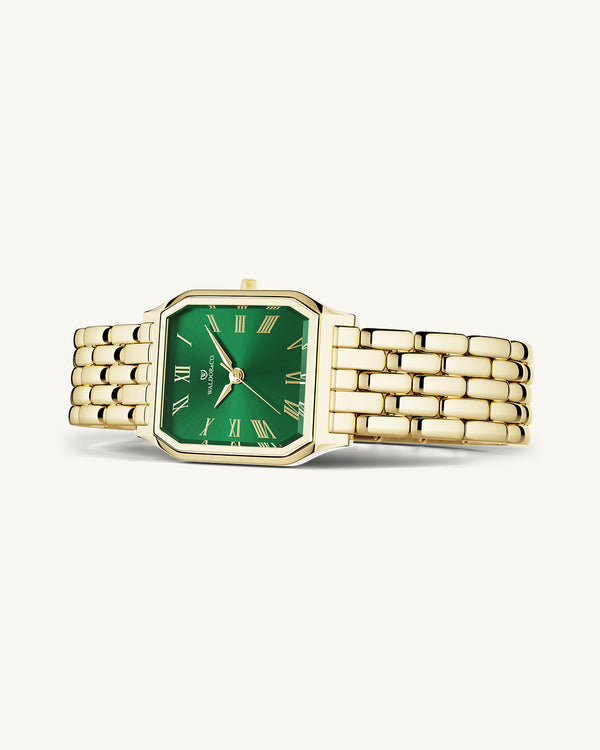 A square womens watch in 22k gold from Waldor & Co. with green Diamond Cut Sapphire Crystal glass dial. Seiko movement. The model is Eternal 22 Bellagio.