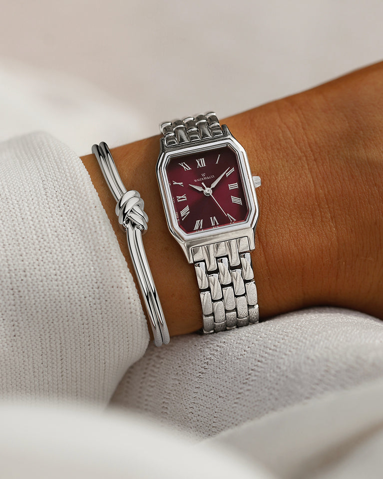 A square womens watch in Rhodium-plated 316L stainless steel from Waldor & Co. with burgundy Diamond Cut Sapphire Crystal glass dial. Seiko movement. The model is Eternal 22 Bellagio.