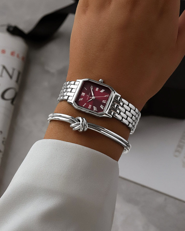 A square womens watch in Rhodium-plated 316L stainless steel from Waldor & Co. with burgundy Diamond Cut Sapphire Crystal glass dial. Seiko movement. The model is Eternal 22 Bellagio.