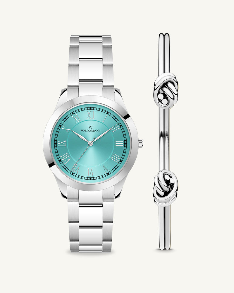 A round womens watch in silver from Waldor & Co. with turquoise sunray dial and a second hand. Seiko movement. The model is Imperial 32 Nocelle 32mm.