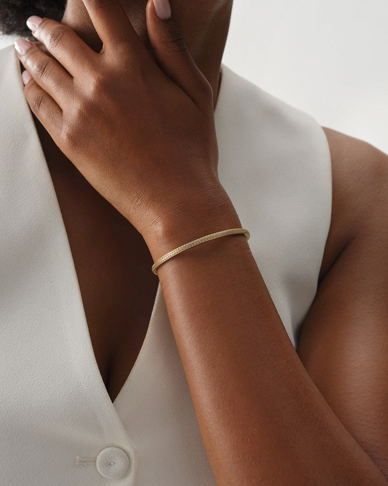 A Bangle in 14k gold plated 316L stainless steel from Waldor & Co. One size. The model is Pavé Bangle Polished.