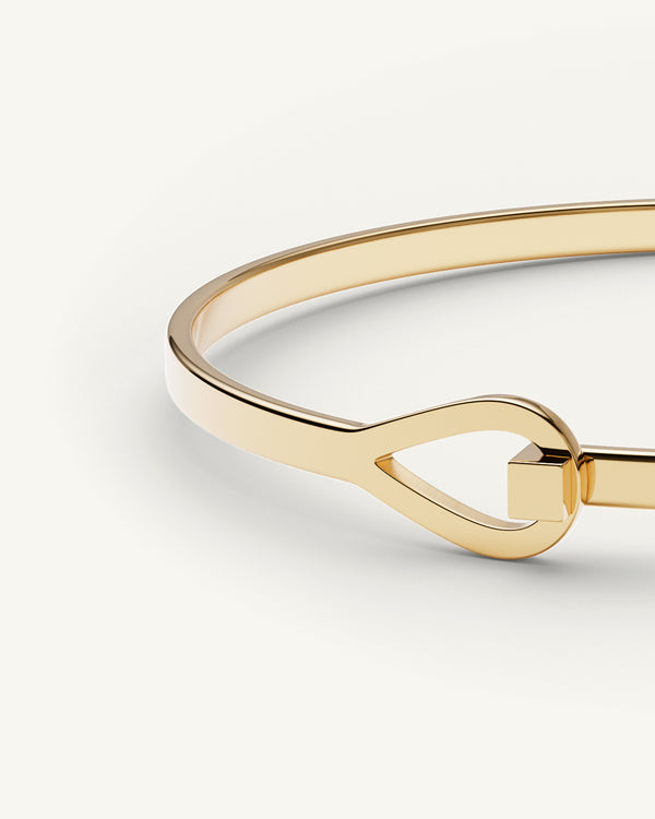 A Bangle in 14k gold plated 316L stainless steel from Waldor & Co. One size. The model is Signature Bangle Polished.