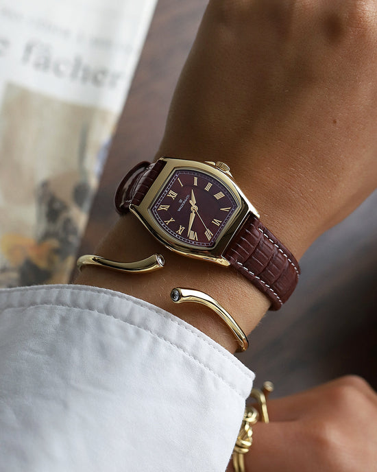 lifestyle_image, A square womens watch in 22k gold plated 316L stainless steel from Waldor & Co. with domed mineral glass dial. Seiko movement. The model is Constant 36 Laglio.