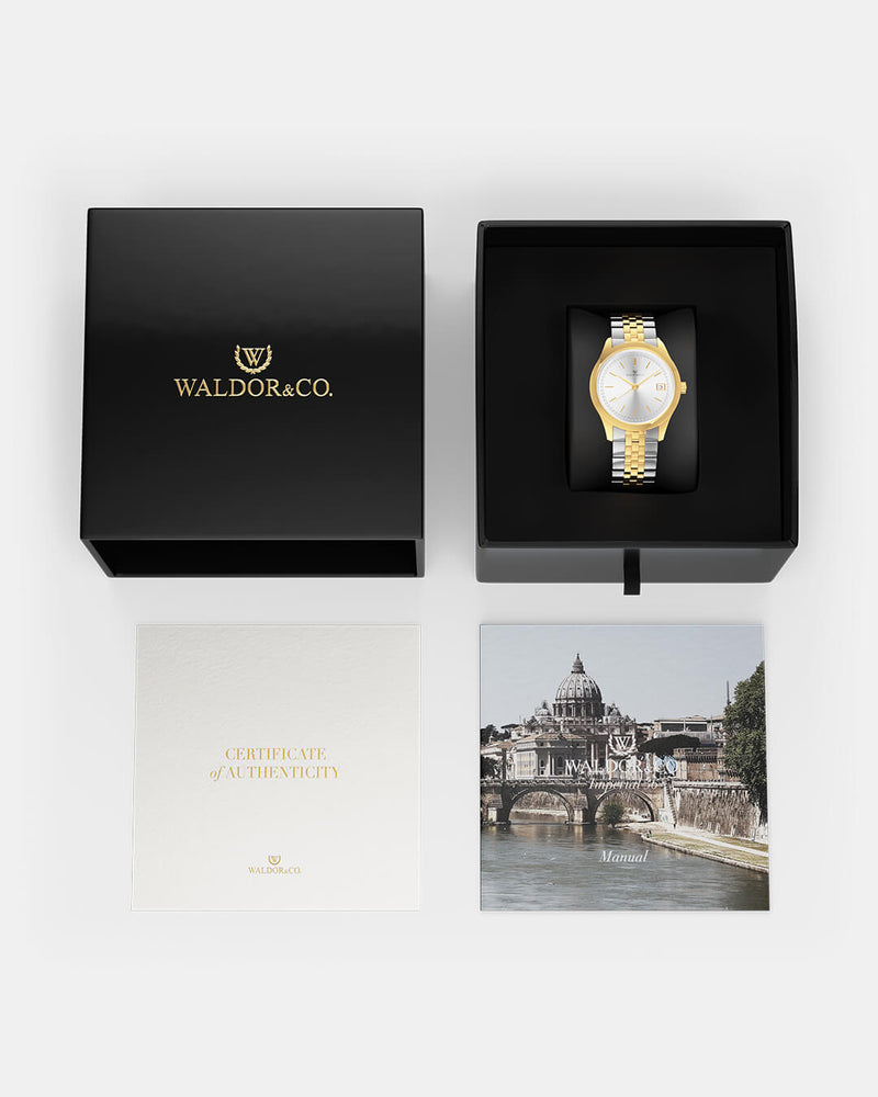 A round womens watch in 14k gold from Waldor & Co. with silver sunray dial and a second hand. Seiko movement. The model is Imperial 36 Roma 36mm.